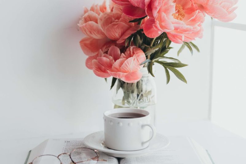 Bible, coffee, flowers and reading glasses for a Bible study
