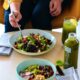 A woman eating a healthy salad The Best Diet For Autoimmune Disease