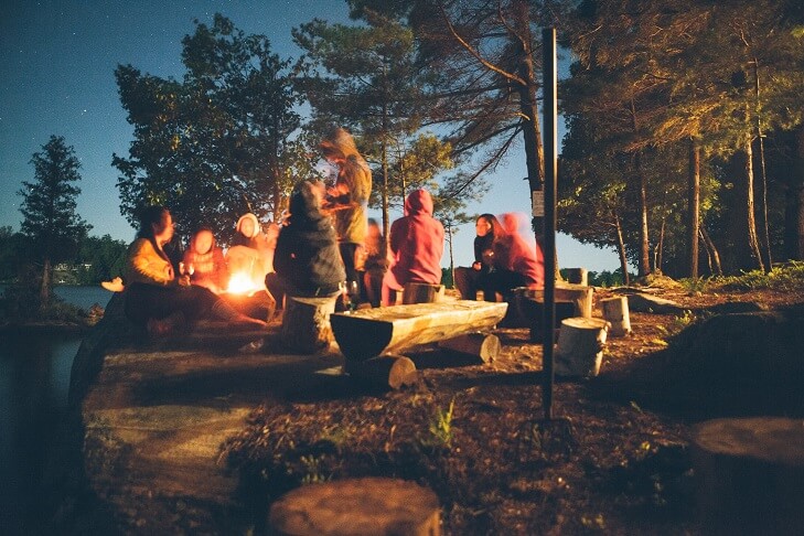 image of a circle of friends around a campfire to show Emotional support for autoimmune disease through your inner circle