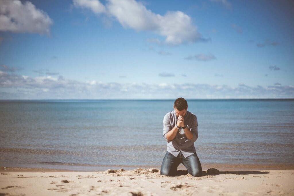 Man on knees in prayer for blog post Obey God With Our Actions And Words
