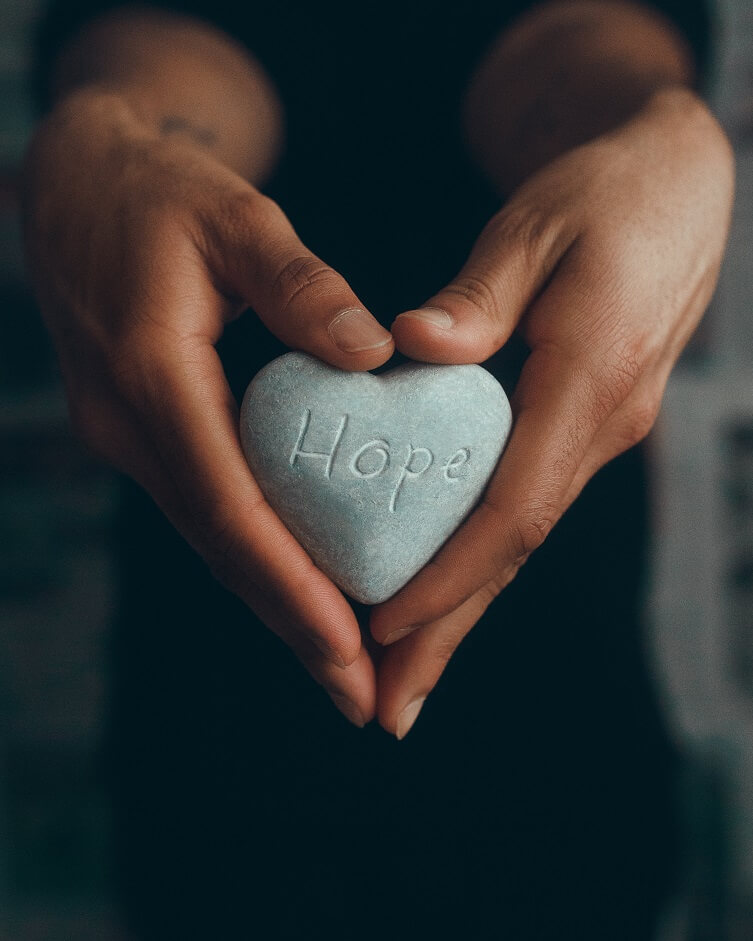 Image of a rock with word HOPE etched and woman holding the rock. For the blog post Can autoimmune disease cause heart problems